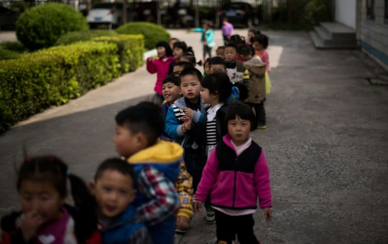 Children in the playground of the Technical Secondary School in Rudong, Jiangsu province. Strict birth control policies have left a dwindling child population