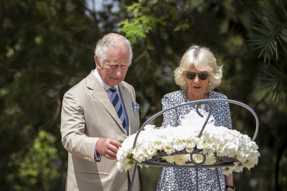 Britain's Prince Charles and Camilla, Duchess of Cornwall, observe a wreath next to the mass graves at the Kigali Genocide Memorial in the capital Kigali, Rwanda Wednesday, June 22, 2022. Prince Charles has become the first British royal to visit Rwanda, representing Queen Elizabeth II as the ceremonial head of the Commonwealth at a summit where both the 54-nation bloc and the monarchy face uncertainty. (AP Photo)