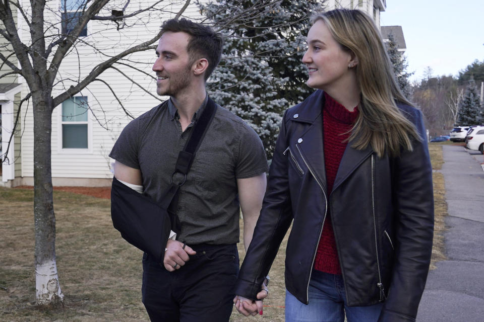 Ryan Johnson, left, walks with Anna Craven outside their home, Friday, Feb. 10, 2023, in Nashua, N.H. The recently engaged couple have also established a transparent financial relationship including being open about individual budgets and having mutual financial goals. Talking about money with your significant other might not be the most romantic topic, but it's a key element of a healthy relationship. (AP Photo/Charles Krupa)