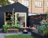 <p> We're head-over-heels for this chic urban plot. It's a brilliant example of how a small space can be transformed into a stylish retreat for relaxing with friends and family. And that garden office is the ideal addition for working from home in style – it's no surprise they’ve had a huge surge in popularity recently. </p> <p> The charcoal-hued privacy fence brings the whole plot together, matching the raised beds and the office structure, and allowing nearby colors of textiles and plants to stand out. Again, a string of festoon lights brings extra warmth to the scene. </p>