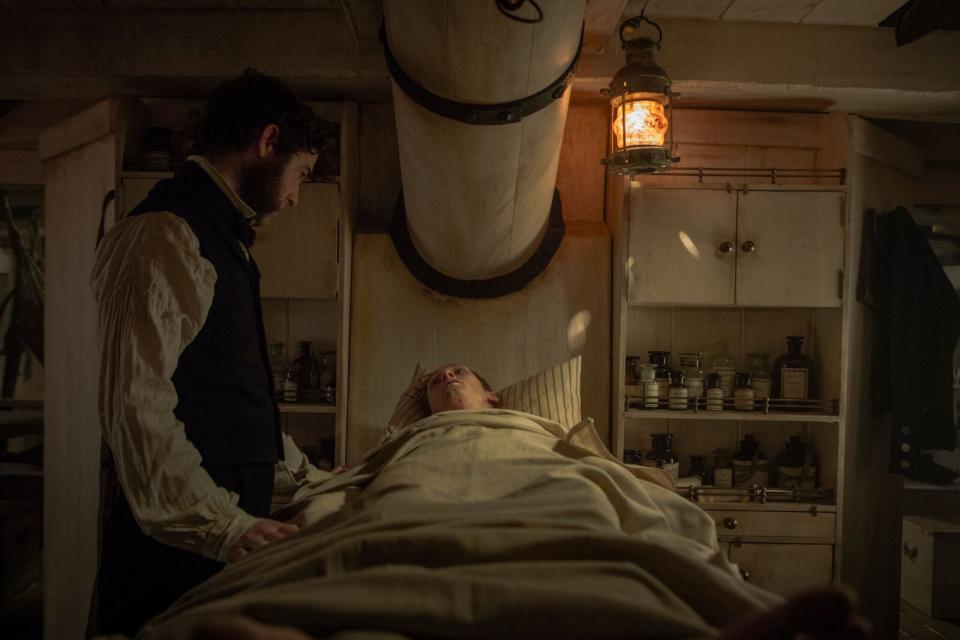 Paul Ready’s Dr Henry Goodsir tends to his patient. (AMC)