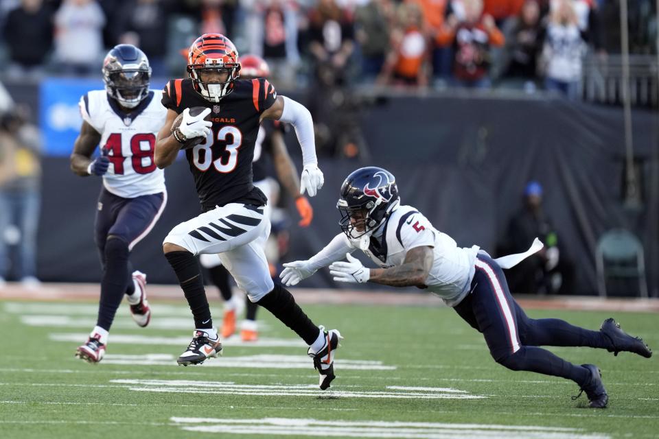 Cincinnati Bengals wide receiver Tyler Boyd (83) breaks away for Houston Texans safety Jalen Pitre (5) after catching a pass during the second half of an NFL football game Sunday, Nov. 12, 2023, in Cincinnati. (AP Photo/Michael Conroy)