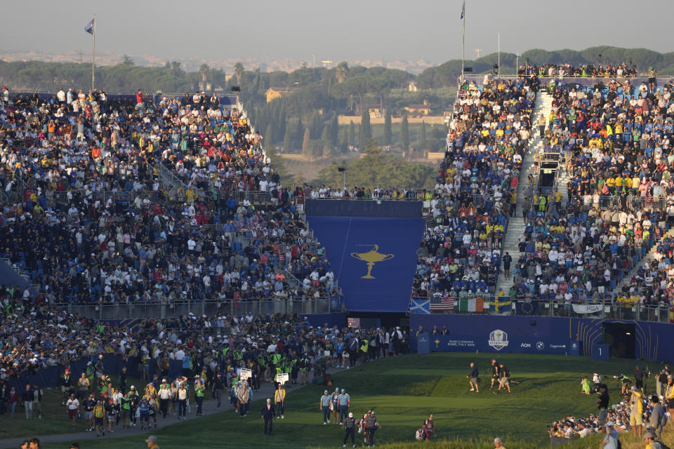 The first morning Foursome match of United States' Scottie Scheffler, and United States' Sam Burns against Europe's Jon Rahm and Europe's Tyrrell Hattonat, leave the 1st tee at the Ryder Cup golf tournament at the Marco Simone Golf Club in Guidonia Montecelio, Italy, Friday, Sept. 29, 2023. (AP Photo/Alessandra Tarantino)