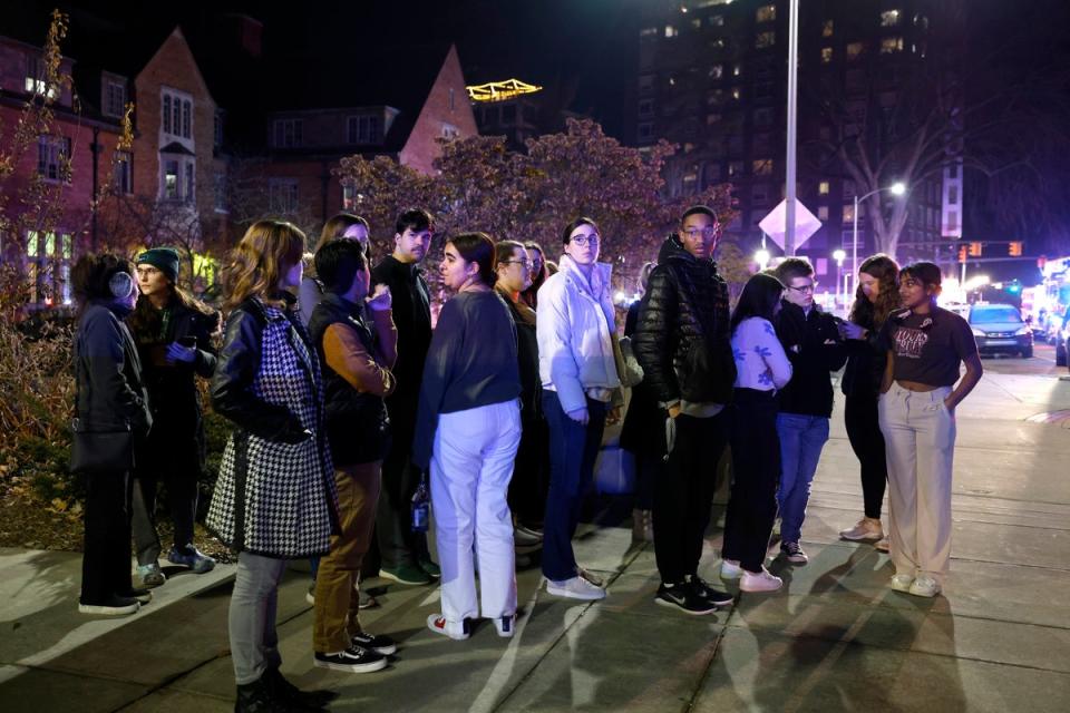 Students gather near the East Lansing campus after Monday night’s shooting (Associated Press)