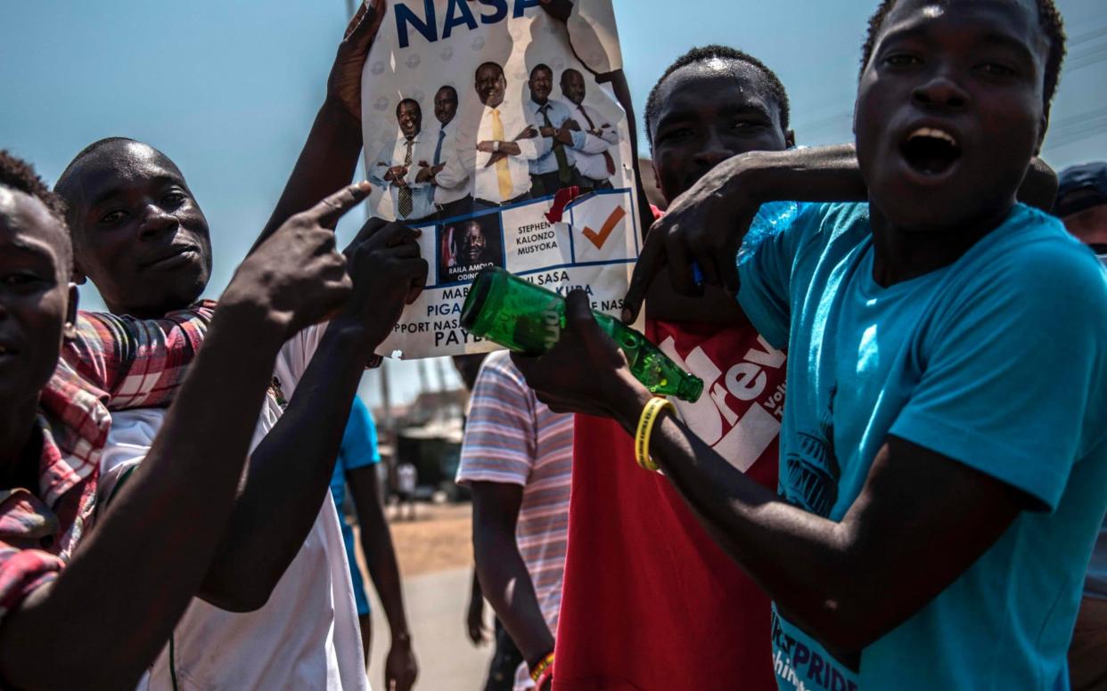 Supporters of Kenyan Opposition leader Raila Odinga shout and gesture during a protest at Kondele on August 9, 2017 in Kisumu, Kenya - AFP