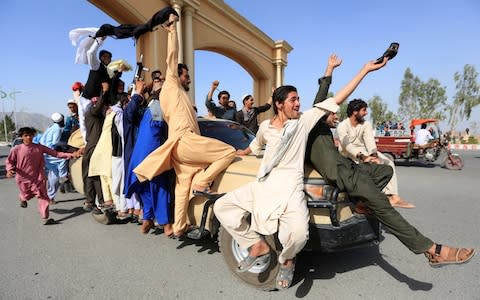 People celebrate ceasefire in Rodat district of Nangarhar province, Afghanistan - Credit: REUTERS/Parwiz