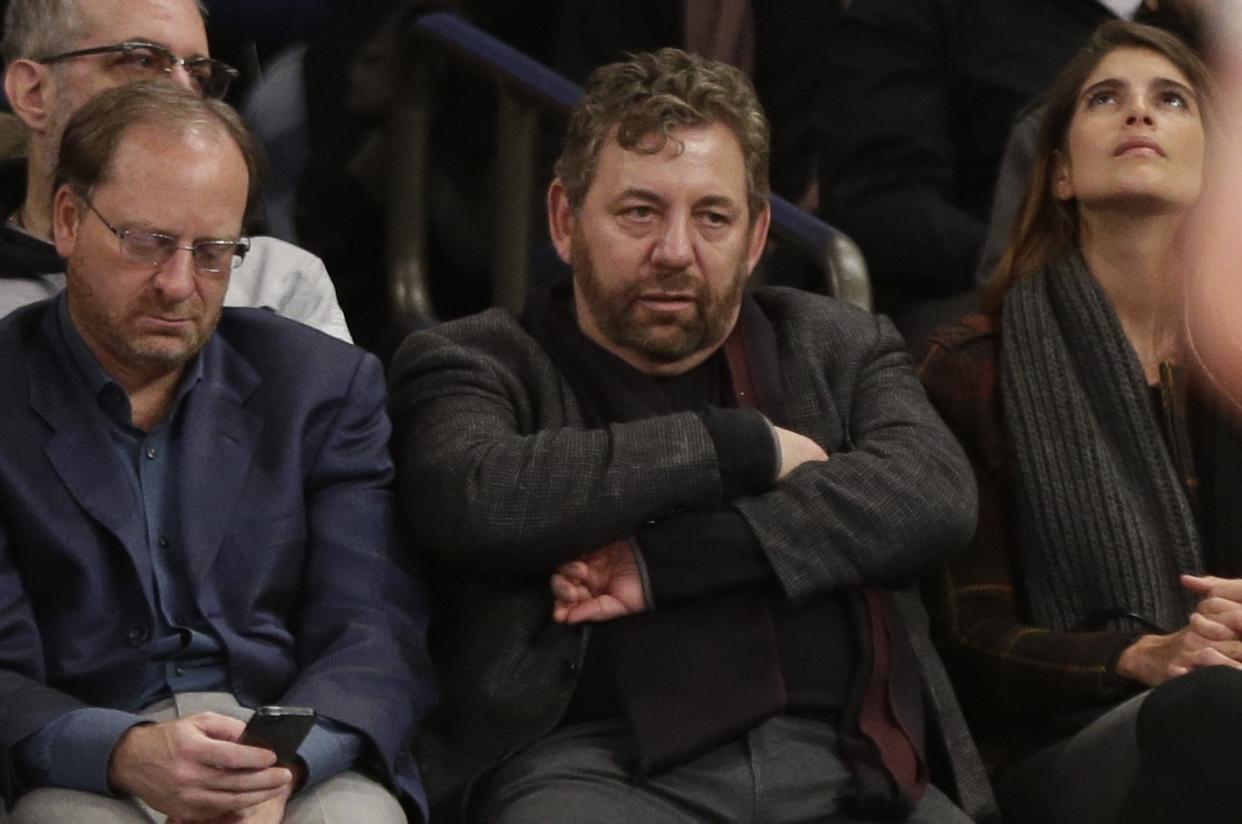 Madison Square Garden Chairman James Dolan, center, reacts during the first half of an NBA basketball game between the New York Knicks and the Charlotte Hornets, Saturday, Jan. 10, 2015, in New York. (AP Photo/Frank Franklin II)