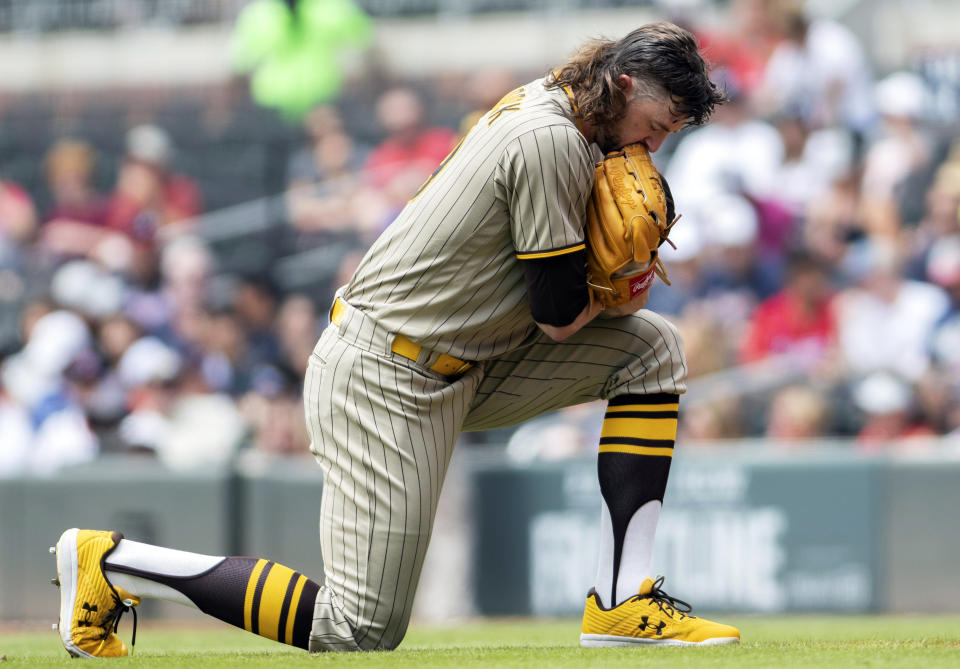 San Diego Padres starting pitcher Chris Paddack (59) takes a knee before baseball game against the Atlanta Braves, Wednesday, July 21, 2021, in Atlanta, GA. (AP Photo/Hakim Wright Sr.)