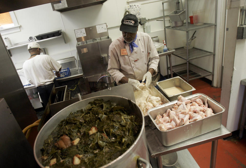 In this Saturday, July 28, 2007 ,file photo, Chef Jim Hollywood works in the kitchen at Sweetie Pie's, a soul food restaurant owned by Robbie Montgomery, in St. Louis. Turning small business owners into stars has become a winning formula for television producers, but some businesses featured in them are cashing in, too. Sales explode after just a few episodes air, transforming these nearly unknown small businesses into household names. (AP Photo/Jeff Roberson)