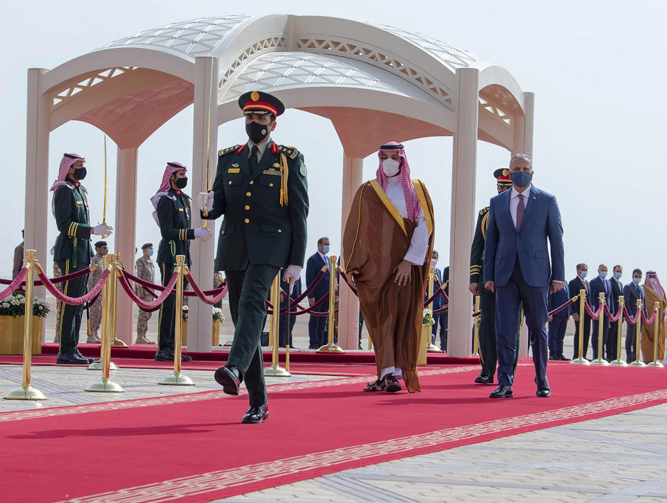 FILE - In this March 31, 2021 file photo, released by the Saudi Royal Palace, Saudi Crown Prince Mohammed bin Salman, center right, accompanies Iraqi Prime Minister Mustafa al-Kadhimi on his arrival to Riyadh International Airport, Saudi Arabia. A first round of direct talks held in April 2021, in Iraq, between regional rivals Saudi Arabia and Iran is seen as a positive sign of de-escalation following years of animosity. The hosting of the talks is also a significant step for Iraq, which has ties with both the U.S. and Iran and has often borne the brunt of Saudi-Iran rivalry. (Bandar Aljaloud/Saudi Royal Palace via AP, File)