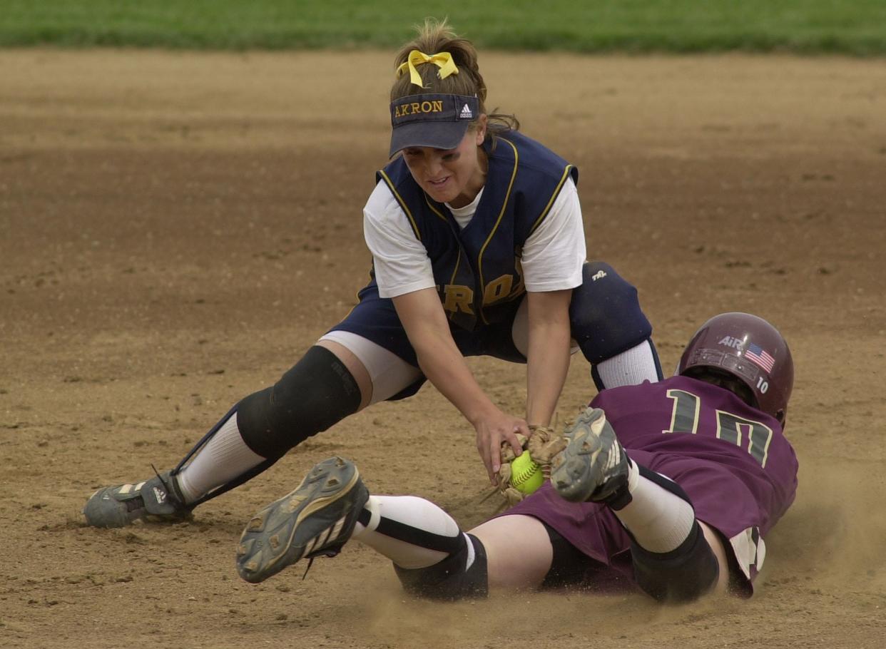 The University of Akron's Tracee McCoy-Jenkins tags out Central Michigan's Becky Manson in the third inning at Firestone Stadium on May 11, 2002. McCoy-Jenkins will be inducted into the Akron Public Schools Athletics Hall of Fame on Oct. 5.