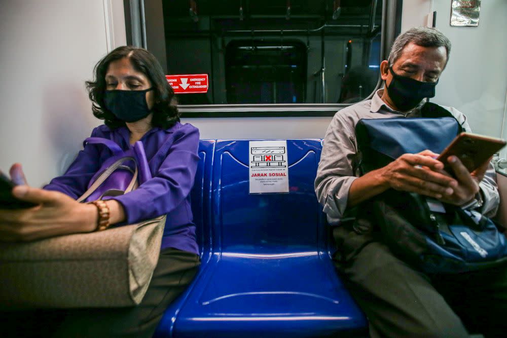 Passengers heed Prasarana’s social distancing advice on board an LRT train March 24, 2020. — Picture by Hari Anggara