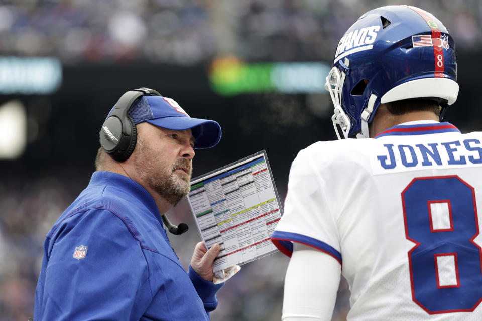 New York Giants interim offensive coordinator Freddie Kitchens talks to Daniel Jones during an NFL football game against the Philadelphia Eagles, Sunday, Nov. 28, 2021, in East Rutherford, N.J. Joe Judge isn't making the Miami Dolphins guess about who will be calling the offensive plays for the Giants this weekend. Former Cleveland Browns coach Freddie Kitchens handled the role against the Eagles after Jason Garrett was fired last week, and he's going to have the headset Sunday when the Giants visit the Dolphins. (AP Photo/Adam Hunger)