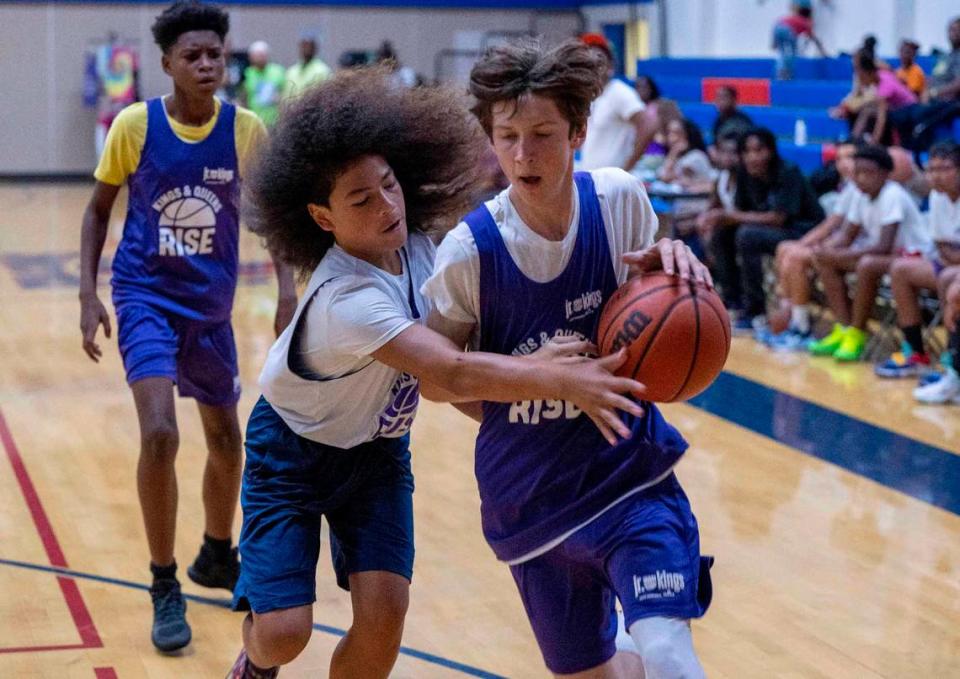 Jalani Brumfield,13, left, tries to steal the ball from Desmond Muhlhauser, 15, during a game Satruday, July 8, 2023, with youth in the Kings and Queens Rise program.