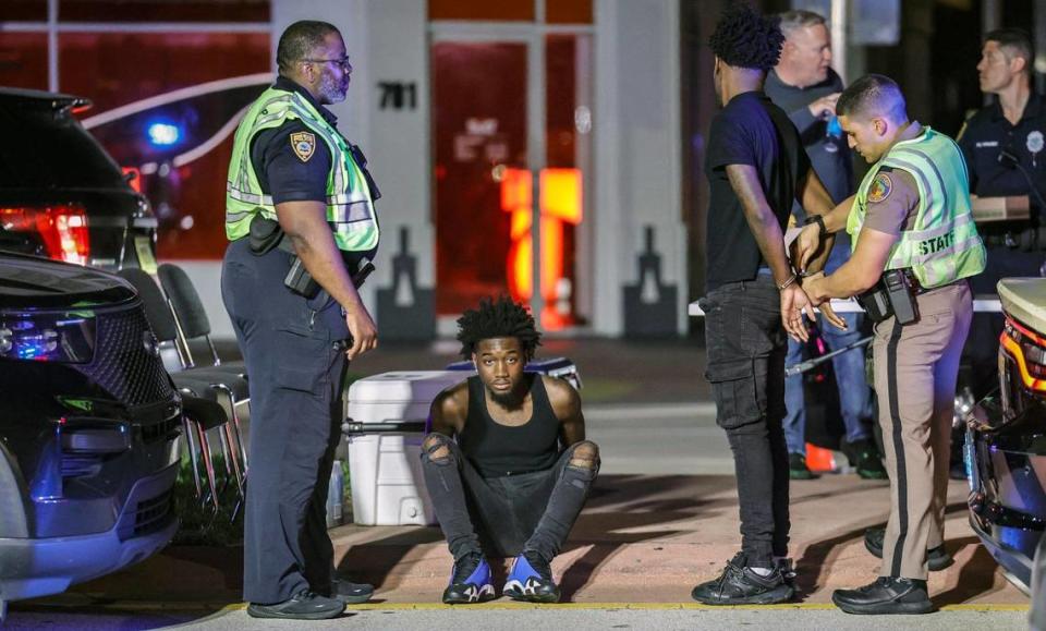 Miami Beach police and Florida Highway Patrol troopers detain visitors to South Beach during spring break in Miami Beach, Florida, on Saturday, March 9, 2024.