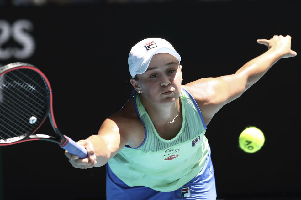 FILE - In this Jan. 28, 2020, file photo, Australia's Ash Barty makes a forehand return to Petra Kvitova of the Czech Republic during their quarterfinal match at the Australian Open tennis championship in Melbourne, Australia. Barty has joined the ranks of high-profile players expressing concern over the staging of the U.S. Open while there’s still so much uncertainty in the coronavirus pandemic. The women’s No. 1 hasn’t had the chance yet to defend her French Open title because all elite tennis competition is shuttered. She’s already processed the fact there’ll be no Wimbledon in 2020 but is still awaiting clarity on the U.S. Open, which is scheduled to begin Aug. 31, 2020. (AP Photo/Dita Alangkara, File)