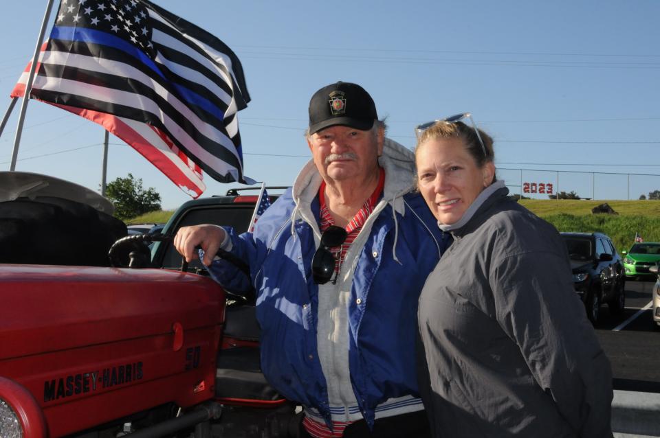 Proud grandfather, Don Shinn and his daughter, Donna Richard, check on two of their family members who drove tractors to school Thursday morning.