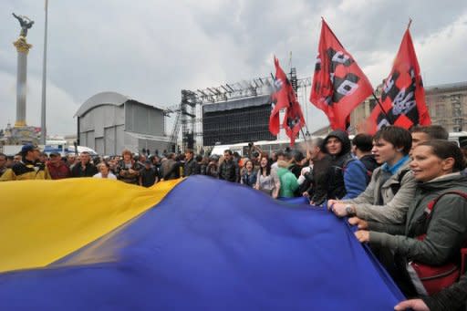 Protesters wave a giant Ukrainian flag during a protest in Kiev on June 5 against a bill increasing the role of the Russian language in the linguistically-divided country. The Euro 2012 football tournament is providing the perfect platform to air a range of local and national grievances in the former Soviet state