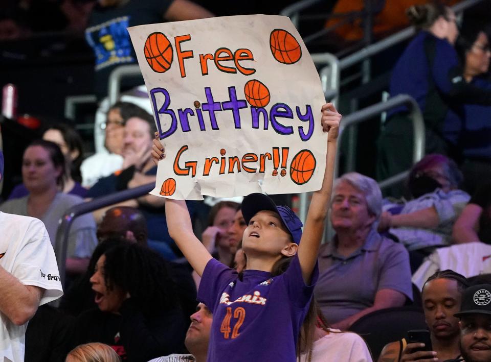 A Phoenix Mercury fan holds up a "Free Brittney Griner" sign during the team's season opener on May 6.