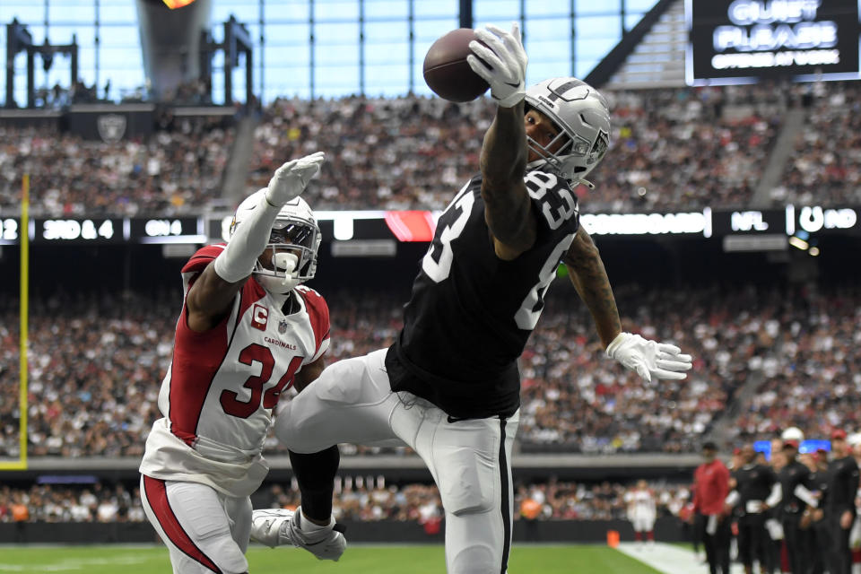 Las Vegas Raiders tight end Darren Waller (83) reaches for a ball in the end zone but cannot make the catch next to Arizona Cardinals safety Jalen Thompson during the first half of an NFL football game Sunday, Sept. 18, 2022, in Las Vegas. (AP Photo/David Becker)