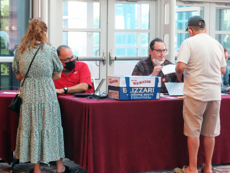 Members of Local 54 of the Unite Here union check in workers on Wednesday, June 15, 2022 before they voted on whether to authorize a strike against the Atlantic City N.J. casinos at the city's Convention Center. (AP Photo/Wayne Parry)