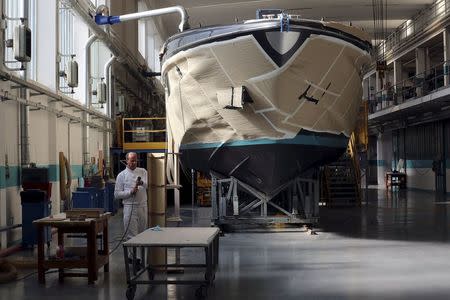 An employee works on a yacht at the Ferretti's shipyard in Sarnico, northern Italy, April 7, 2015. Picture taken on April 7, 2015. REUTERS/Stefano Rellandini