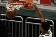 Milwaukee Bucks' Giannis Antetokounmpo dunks during the first half of an NBA basketball game against the Denver Nuggets Tuesday, March 2, 2021, in Milwaukee. (AP Photo/Morry Gash)