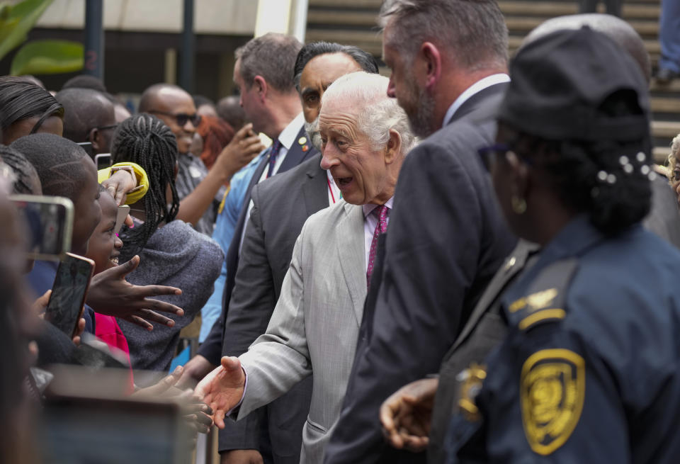 Britain's King Charles III, centre, greats members of the public, during a visit to the United Nations Office, in Nairobi, Kenya Wednesday, Nov. 1, 2023. (AP Photo/Brian Inganga, Pool)