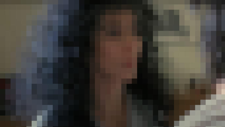 Cher looks annoyed in Moonstruck, pixelated.