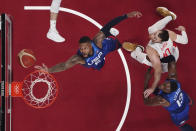 United States' Damian Lillard (6) drives to the basket past Spain's Victor Claver (10) during a men's basketball quarterfinal game at the 2020 Summer Olympics, Wednesday, July 28, 2021, in Saitama, Japan. (Brian Snyder/Pool Photo via AP)