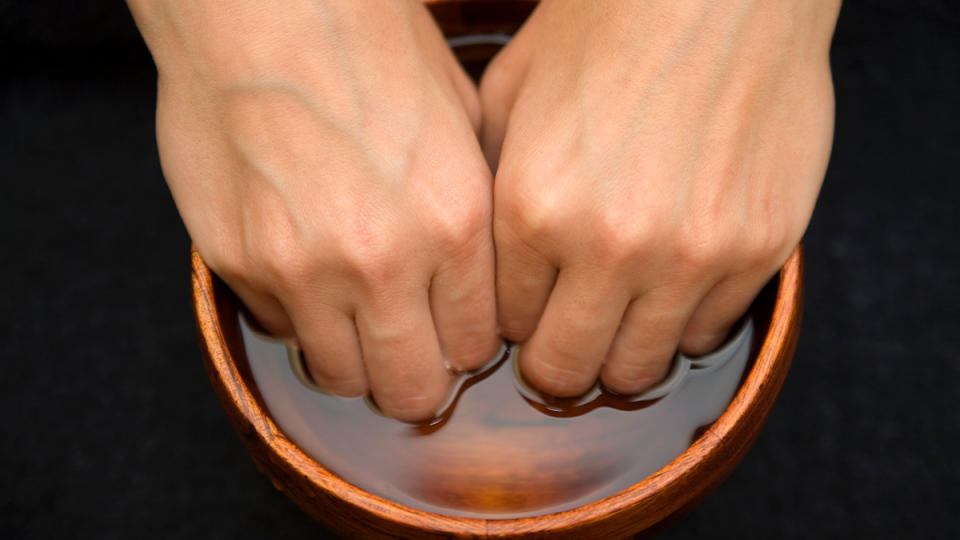 nails soaking in bowl of acetone