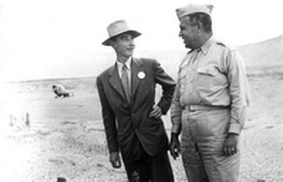 J. Robert Oppenheimer and General Leslie R. Groves at Trinity Site next to the remains of the Trinity Tower in September 1945.