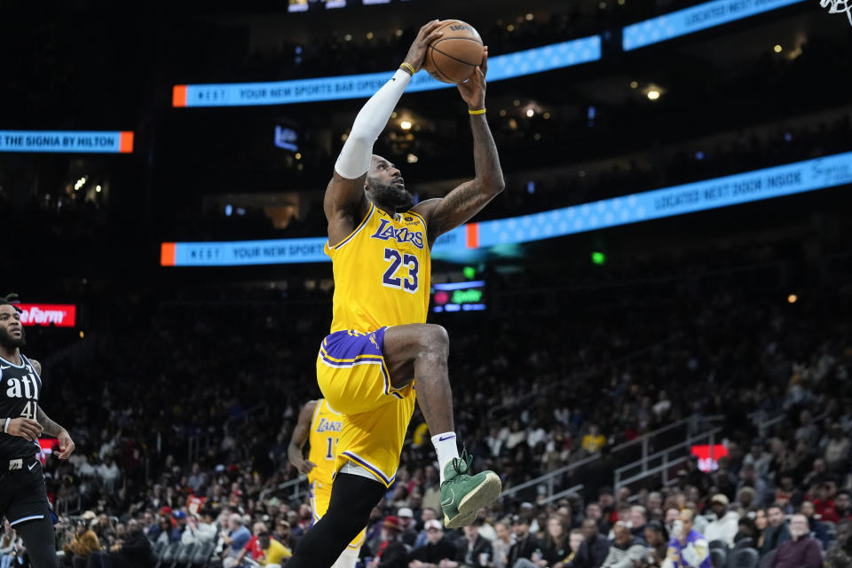 Los Angeles Lakers forward LeBron James (23) scores against the Atlanta Hawks in the second half of an NBA basketball game Tuesday, Jan. 30, 2024, in Atlanta. (AP Photo/John Bazemore)