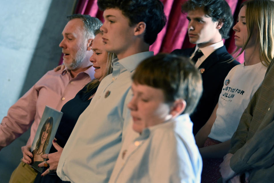 Matt Ludwig, left, Jessica Ludwig holding a a photo of their daughter Jillian, sons, Trevor and Shane, right, react after a bill passed in the House that would allow a judge to send a person facing criminal charges, but not competent for trial, to a mental health facility and the person would not be able to processes or purchase a handgun Monday, April 15, 2024, in Nashville, Tenn. The bill is named for Jillian Ludwig, a Belmont University student killed last year by a stray bullet shot allegedly by a man the court had previously declared mentally incompetent. (AP Photo/Mark Zaleski)