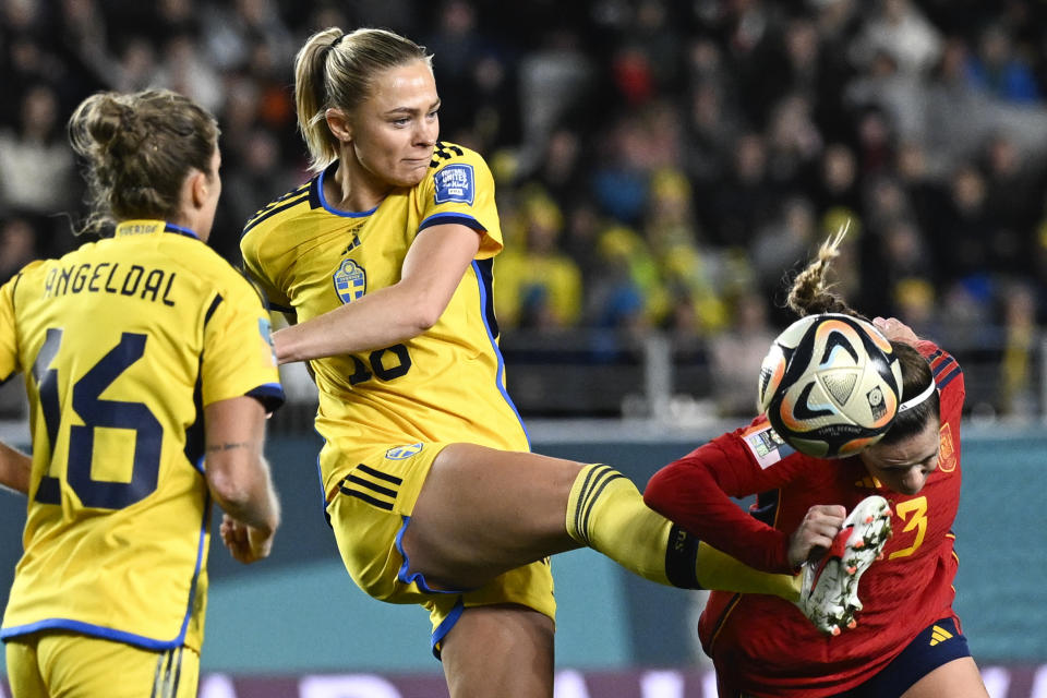 Sweden's Fridolina Rolfo attempts to kick the ball clear of Spain's Teresa Abelleira, right, during the Women's World Cup semifinal soccer match between Sweden and Spain at Eden Park in Auckland, New Zealand, Tuesday, Aug. 15, 2023. (AP Photo/Andrew Cornaga)