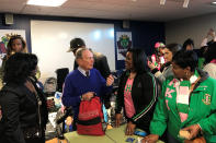 In this Jan. 20, 2020, photo, former New York City Mayor and presidential candidate Michael Bloomberg talks to volunteers assembling backpacks at Scholarmade Achievement Place in Little Rock, Ark. (AP Photo/Andrew DeMillo)