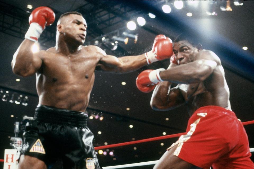 Mike Tyson (left) in action against Frank Bruno in 1989 (Getty)