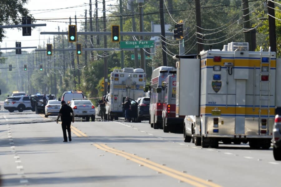 Authorities respond to the scene of a mass shooting at a Dollar General store, Saturday, Aug. 26, 2023, in Jacksonville, Fla. (AP Photo/John Raoux)