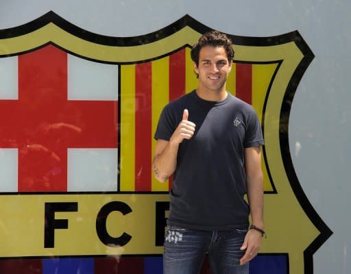 Barcelona's new player Cesc Fabregas gives the thumb up outside Camp Nou's stadium in Barcelona. Fabregas completed his marathon move from Arsenal to Barcelona by signing a five-year contract that brought him "back home" to his boyhood club after eight years