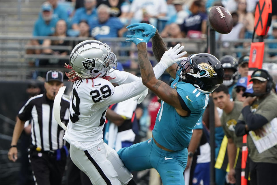 Las Vegas Raiders cornerback Anthony Averett (29) breaks up a pass intended for Jacksonville Jaguars wide receiver Marvin Jones Jr. (11) in the first half of an NFL football game Sunday, Nov. 6, 2022, in Jacksonville, Fla. (AP Photo/John Raoux)