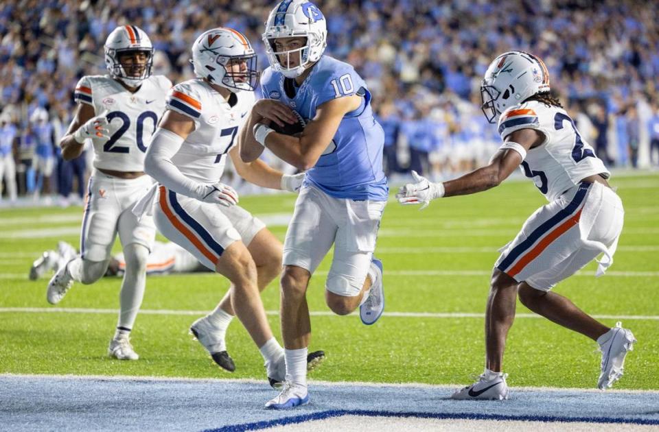 North Carolina quarterback Drake Maye (10) scores on a three-yard run in the third quarter to give the Tar Heels’ a 24-14 lead over Virginia on Saturday, October 21, 2023 at Kenan Stadium in Chapel Hill, N.C.