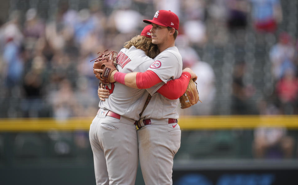 St. Louis Cardinals shortstop Brendan Donovan, left, hugs second baseman Nolan Gorman after the team's win over the Colorado Rockies in a baseball game Wednesday, April 12, 2023, in Denver. (AP Photo/David Zalubowski