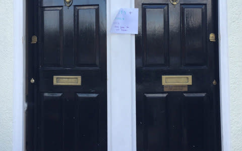  A note pinned outside two houses close to Parsons Green station in London welcoming strangers inside - Credit: Tess De La Mare /PA