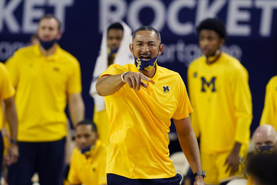 FILE - Michigan head coach Juwan Howard directs from the sideline during the second half of an NCAA college basketball game against Michigan State in Ann Arbor, Mich., in this Thursday, March 4, 2021, file photo. Michigan coach Juwan Howard was honored as The Associated Press men's basketball coach of the year Thursday, April 1, 2021.(AP Photo/Carlos Osorio, File)