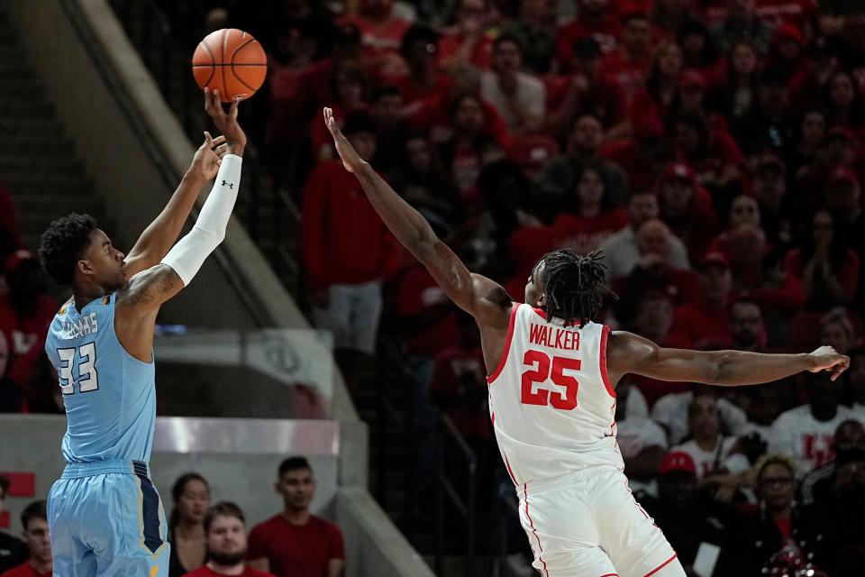 Kent State forward Miryne Thomas (33) shoots over Houston forward Jarace Walker (25) during the first half of an NCAA college basketball game Saturday, Nov. 26, 2022, in Houston. (AP Photo/Kevin M. Cox)