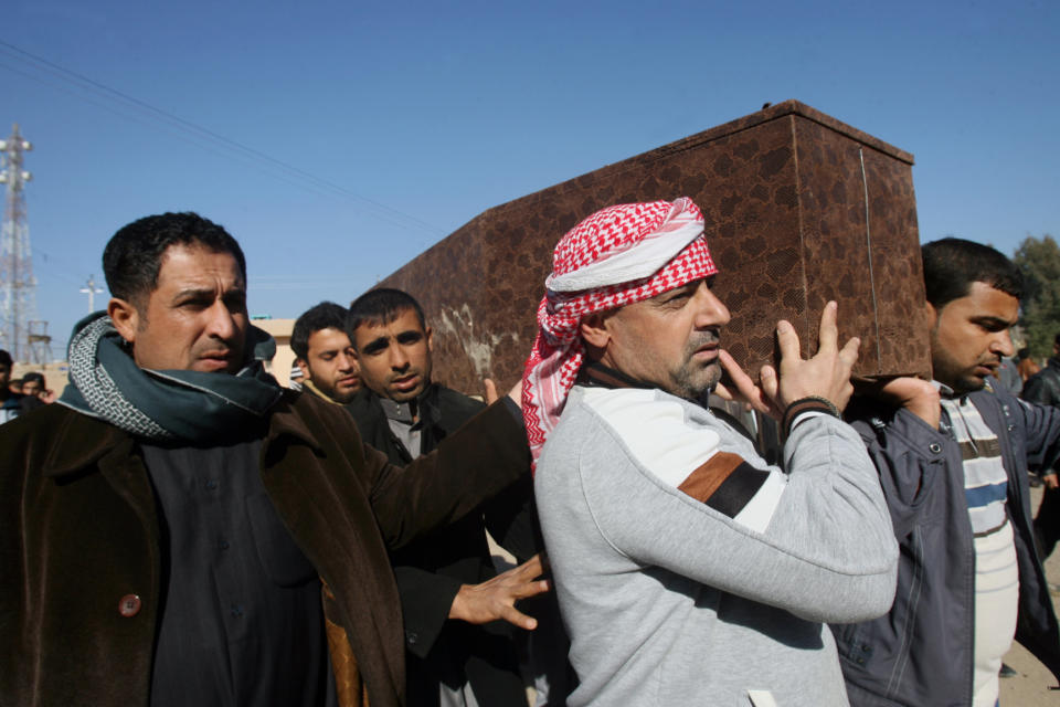 Mourners carry the coffin of Yazn Jassim Mohammed, 24, who was killed when clashes erupted between al-Qaida gunmen and Iraqi army soldiers on Tuesday, his family said, during his funeral in Fallujah, 40 miles (65 kilometers) west of Baghdad, Iraq, Wednesday, Jan. 8, 2014. Iraq's Prime Minister Nouri al-Maliki urged al-Qaida-linked fighters who have overrun two cities west of Baghdad to give up the battle, vowing Wednesday to press forward with a push to regain control of the mainly Sunni areas. (AP Photo)