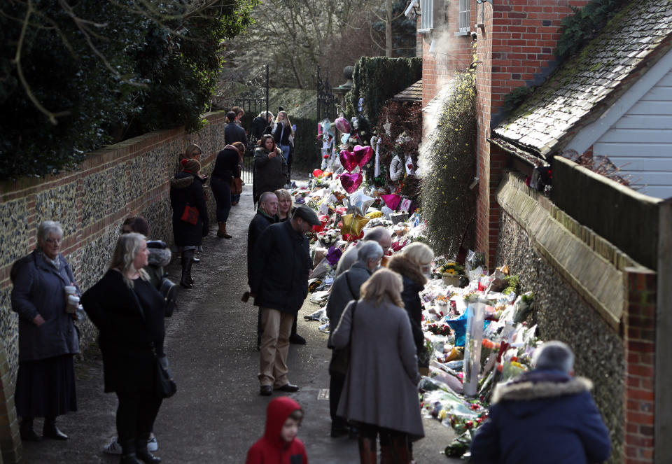 Members of the public view floral tributes outside the home of George Michael in Goring-on-Thames, Oxfordshire, after he died on Christmas Day aged 53.