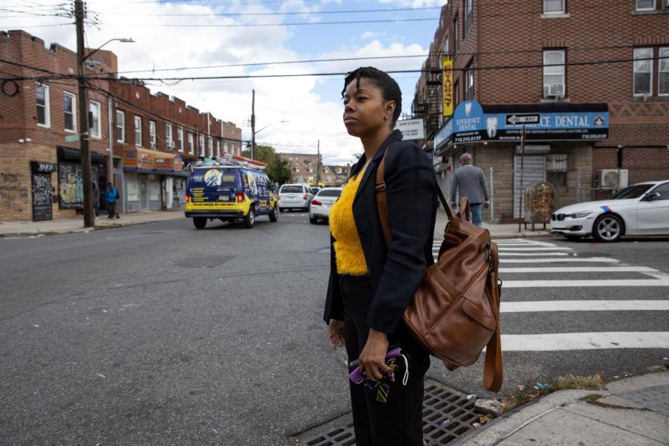 Nicole Sharpe waits to cross the street in New York (Reuters)