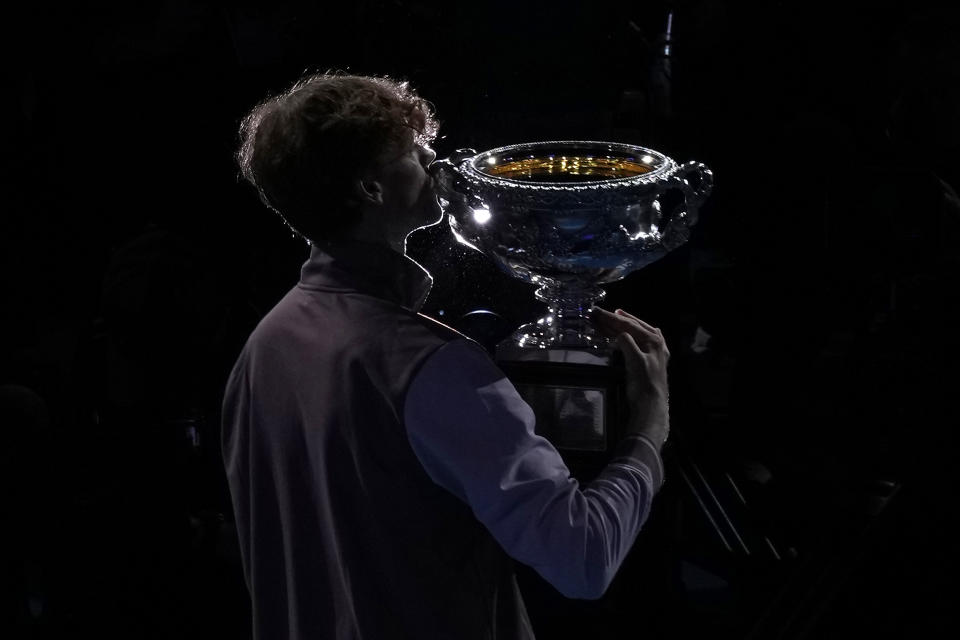 Jannik Sinner of Italy kisses the Norman Brookes Challenge Cup after defeating Daniil Medvedev of Russia in the men's singles final at the Australian Open tennis championships at Melbourne Park, in Melbourne, Australia, Sunday, Jan. 28, 2024. (AP Photo/Alessandra Tarantino)