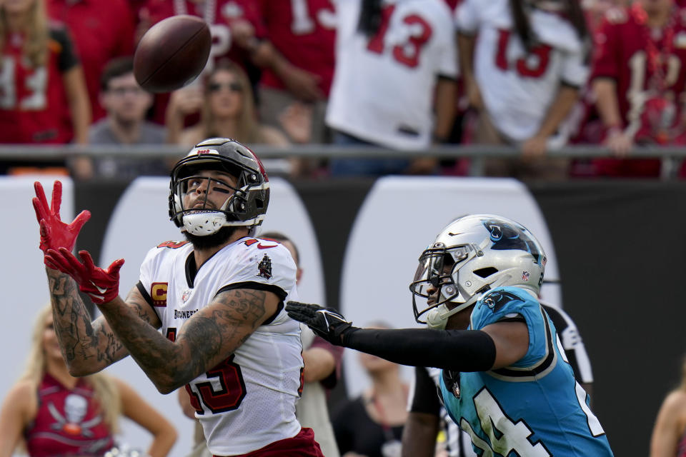 Tampa Bay Buccaneers wide receiver Mike Evans scores in front of Carolina Panthers cornerback CJ Henderson during the second half of an NFL football game between the Carolina Panthers and the Tampa Bay Buccaneers on Sunday, Jan. 1, 2023, in Tampa, Fla. (AP Photo/Chris O'Meara)